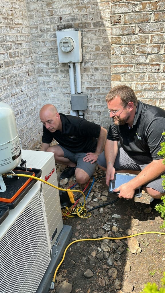 two skilled technicians repairing an ac